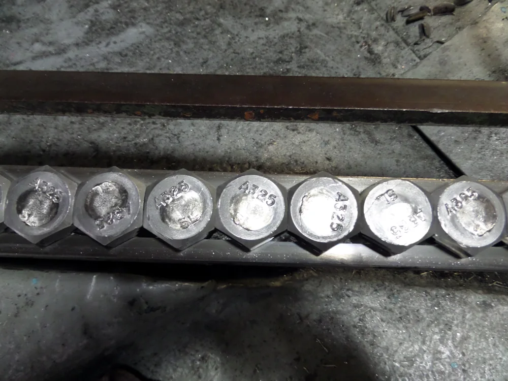 Bolt heads moving through a production machine