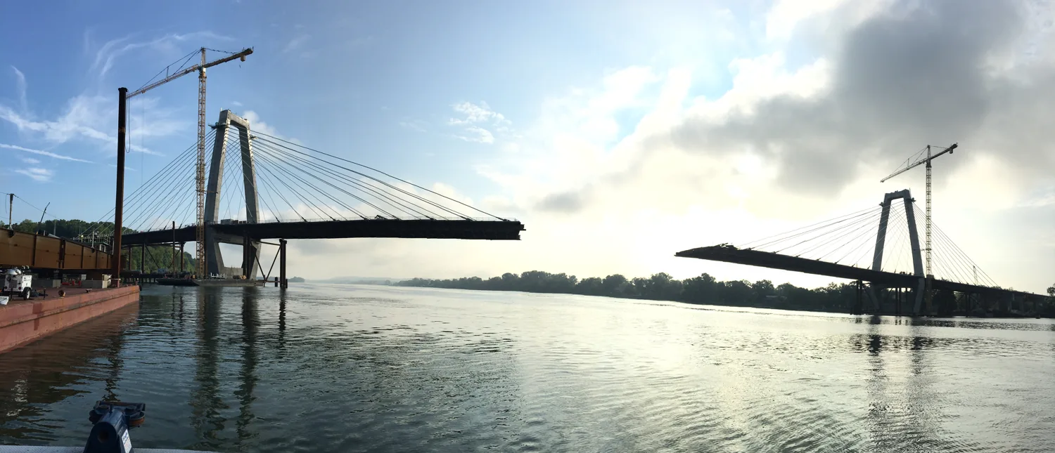 Cable-stayed bridge under construction across a river