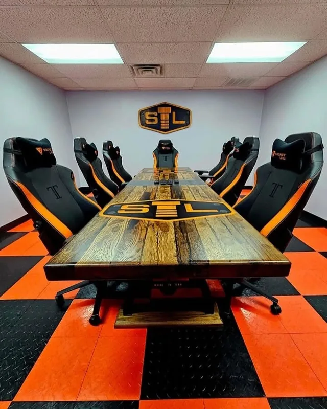 SLSB conference room with orange and black chairs and branded meeting table