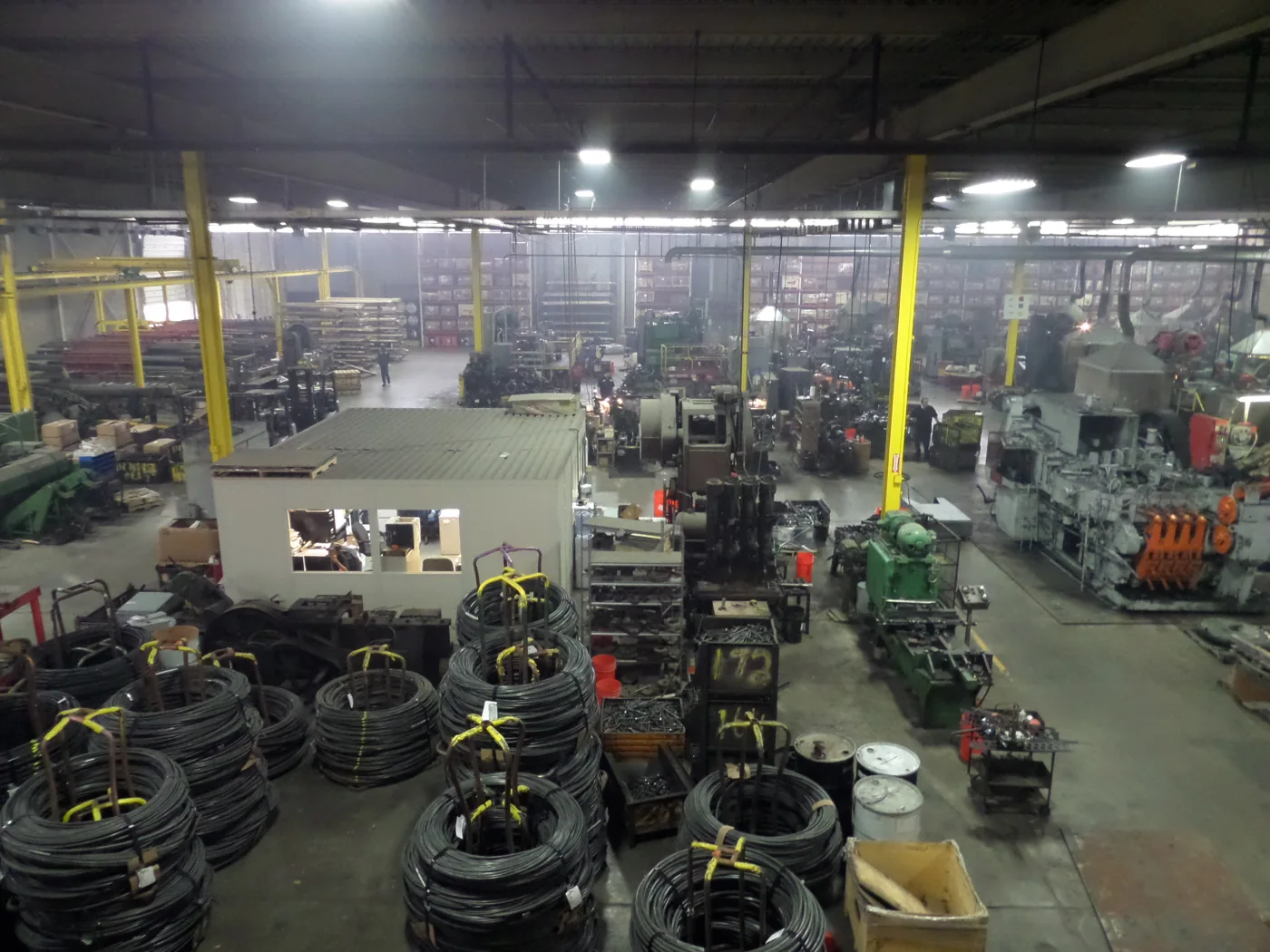 Wide view of SLSB manufacturing floor with steel coils and production equipment